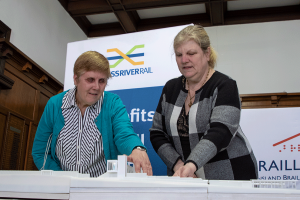 2 people reading the Braille on the 3D model
