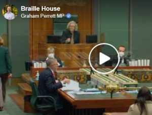 Picture from Australian Parliament with a person sitting in a seat above others
