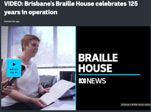 Screenshot from the video of a woman showing a braille page. also reads: Braille House